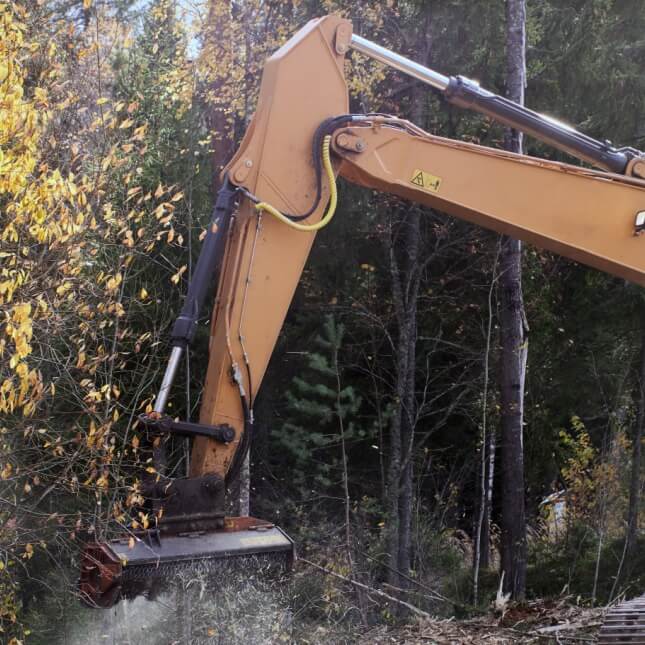 excavator with mulcher in action
